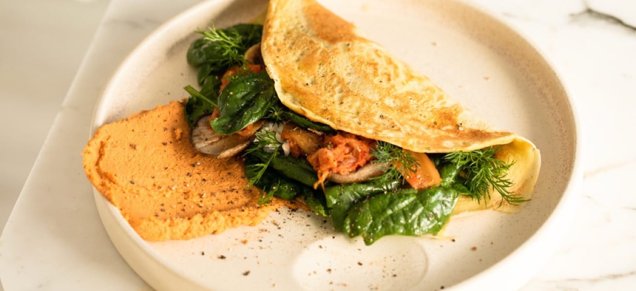 An omelette with toast on a light colored plate